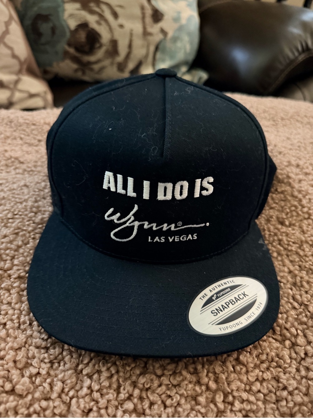 ALL I DO IS WYNN The Classic Black Snapback Hat with White Logo